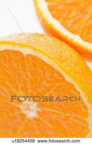 Stock Photo - Close up of halved orange against white background.. Fotosearch