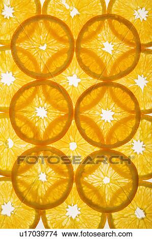Picture - Orange slices arranged in design on white background.. Fotosearch