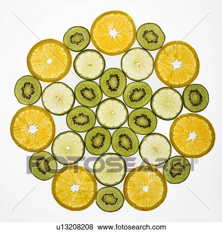 Stock Photo - Assorted fruit slices arranged in pattern on white background.. Fotosearch