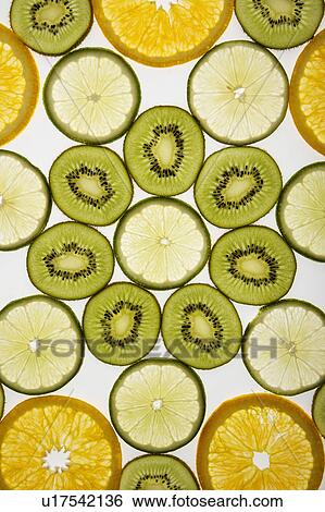 Assorted fruit slices arranged in pattern on white background. View Large Photo Image Stock Photograph - Assorted fruit slices arranged in pattern on white background.. Fotosearch