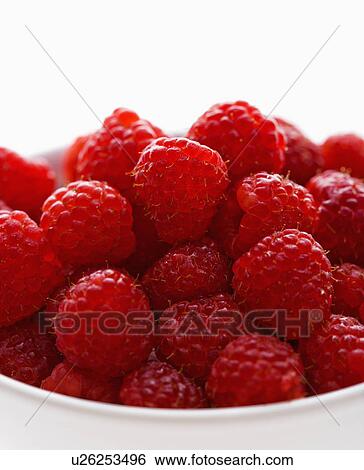 Stock Photograph - Bowl of raspberries against white background.. Fotosearch