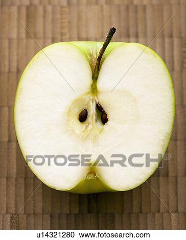 Stock Image - Close up of sliced green apple.. Fotosearch