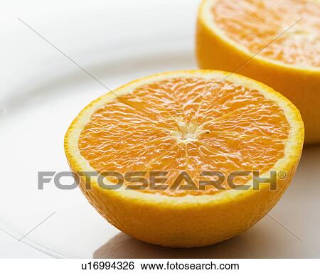 Stock Photograph - Halved orange against white background.. Fotosearch