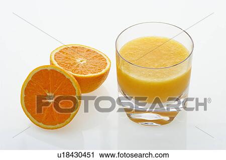 Stock Image - Halved orange and glass of orange juice on white background.. Fotosearch