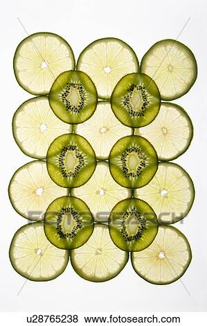 Stock Photo - Lime and kiwi fruit slices arranged on white background.. Fotosearch