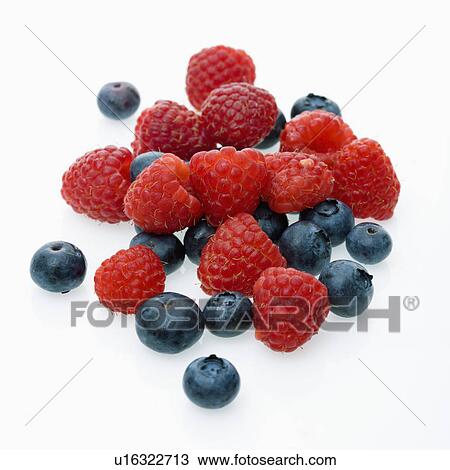 Stock Image - Mixed blueberries and raspberries on white background.. Fotosearch