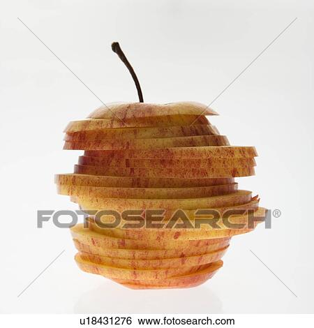Stock Photograph - Red apple sliced and stacked against white background.. Fotosearch
