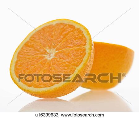Stock Image - Still life of halved orange against white background.. Fotosearch