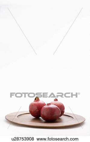 3 pomegranates on wooden plate View Large Photo Image Stock Photo - 3 pomegranates on wooden plate. Fotosearch
