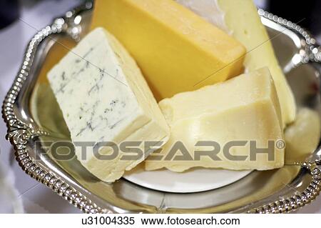 Bricks of blue, cheddar, parmesan, and brie cheese in a silver dish View Large Photo Image Stock Photography - Bricks of blue, cheddar, parmesan, and brie cheese in a silver dish. Fotosearch