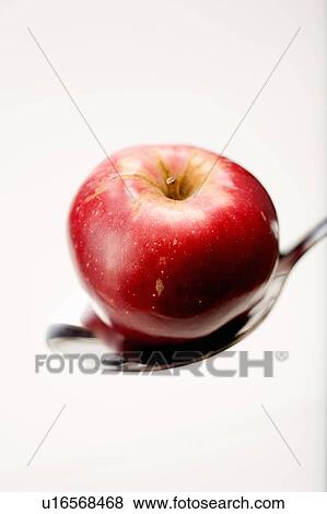 Stock Photo - Organic apple in spoon. Fotosearch
