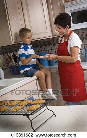 Grandma and grandson baking cookies View Large Photo Image Stock Image - Grandma and grandson baking cookies. Fotosearch