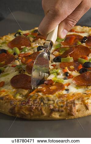 Man cutting pizza View Large Photo Image Stock Image - Man cutting pizza. Fotosearch