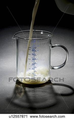 Milk being poured into measuring cup View Large Photo Image Stock Image - Milk being poured into measuring cup. Fotosearch