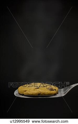 Stock Photo - Warm cookie on spatula. Fotosearch