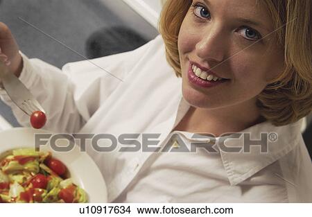 Woman eating salad View Large Photo Image Picture - Woman eating salad. Fotosearch