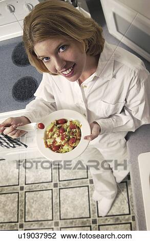 Stock Image - Woman eating salad. Fotosearch