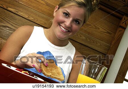 Woman having breakfast in bed View Large Photo Image Stock Image - Woman having breakfast in bed. Fotosearch