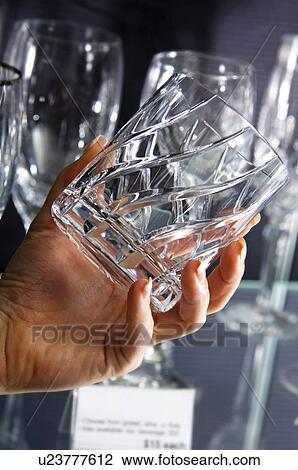 Stock Image - Woman shopping for glasses. Fotosearch