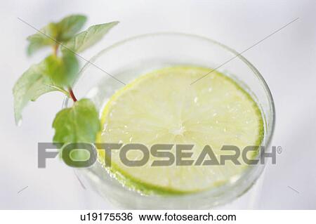Stock Photograph - A glass of lemon water, close-up. Fotosearch