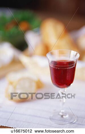 A glass of red wine with bread in the background View Large Photo Image Stock Image - A glass of red wine with bread in the background. Fotosearch
