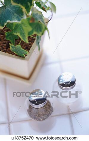 Stock Image - Salt, pepper and potted plant. Fotosearch
