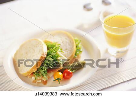 Stock Image - Sandwiches and glass of orange juice. Fotosearch