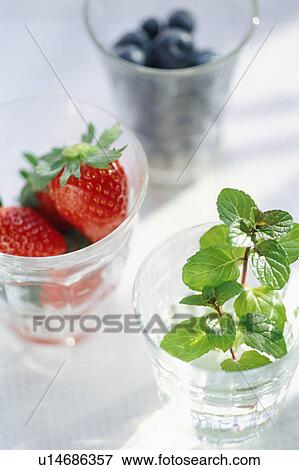 Stock Photo - Strawberries and berries in glasses. Fotosearch