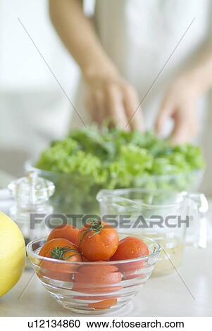 Stock Image - A woman preparing salad. Fotosearch