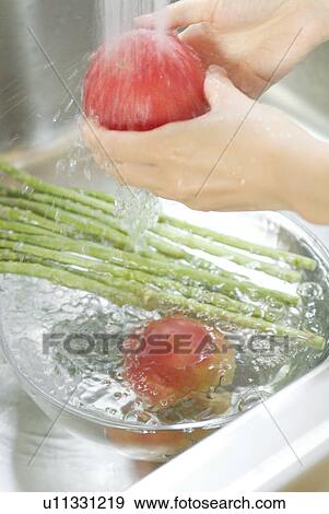 A woman washing vegetables View Large Photo Image Stock Photo - A woman washing vegetables. Fotosearch
