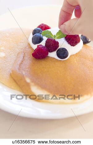 Decorating pancake with berries View Large Photo Image Stock Photography - Decorating pancake with berries. Fotosearch