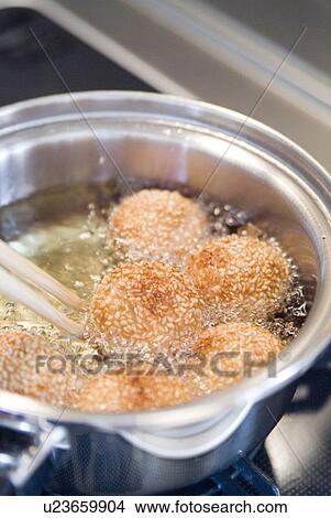 Deep frying sesame seed balls View Large Photo Image Picture - Deep frying sesame seed balls. Fotosearch