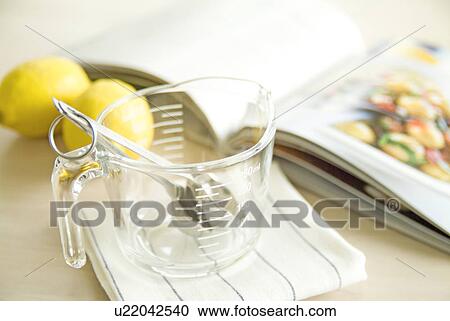 Stock Image - Measuring cup in kitchen. Fotosearch