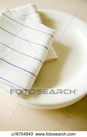 Stock Image - Plates and dish towels. Fotosearch