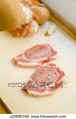 Preparing pork steaks View Large Photo Image Stock Photo - Preparing pork steaks. Fotosearch