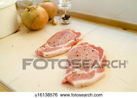 Preparing pork steaks View Large Photo Image Stock Photograph - Preparing pork steaks. Fotosearch