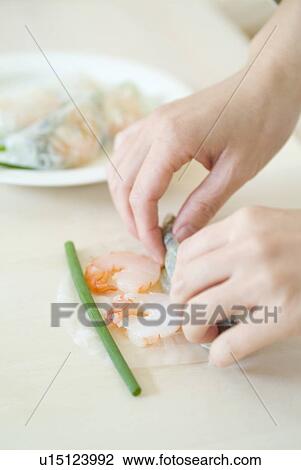 Stock Image - Preparing spring rolls. Fotosearch