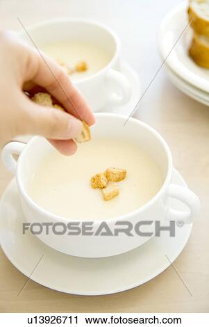Putting crouton in soup View Large Photo Image Stock Image - Putting crouton in soup. Fotosearch