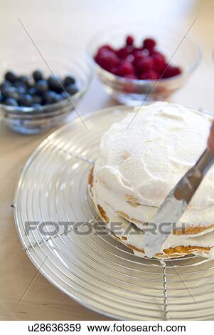 Stock Photo - Putting whipped cream on pancake. Fotosearch