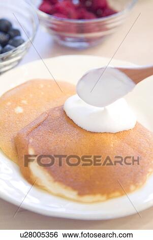 Putting whipped cream on pancake View Large Photo Image Stock Photograph - Putting whipped cream on pancake. Fotosearch