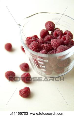 Stock Image - Raspberries in measuring jug. Fotosearch