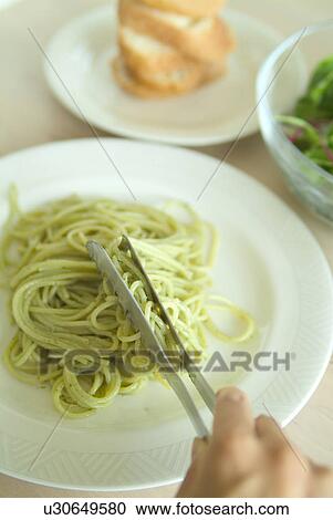 Serving spaghetti on plate View Large Photo Image Stock Image - Serving spaghetti on plate. Fotosearch