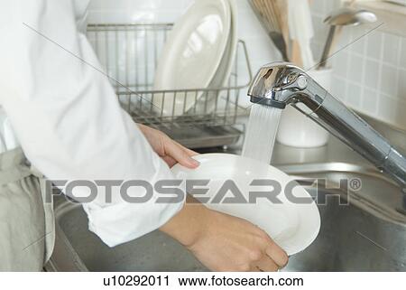 Washing dishes in kitchen sink View Large Photo Image Stock Image - Washing dishes in kitchen sink. Fotosearch