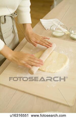 Stock Image - Woman rolling dough. Fotosearch