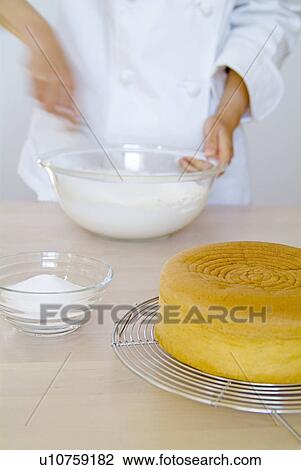 Stock Image - A woman mixing cream, blurred motion. Fotosearch