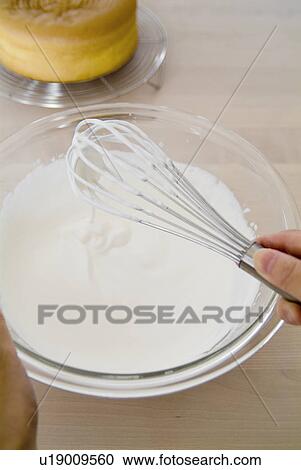 A woman mixing cream View Large Photo Image Stock Image - A woman mixing cream. Fotosearch