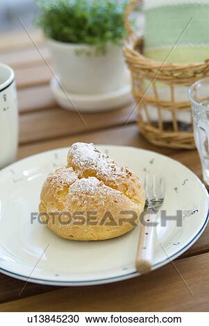 Stock Image - Cream puff on plate. Fotosearch