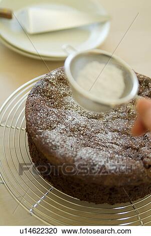 Decorating a cake with powder sugar View Large Photo Image Stock Image - Decorating a cake with powder sugar. Fotosearch