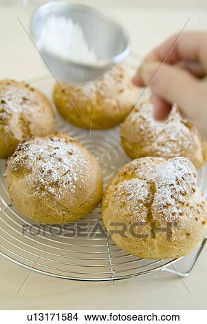 Decorating cream puff with powder sugar View Large Photo Image Picture - Decorating cream puff with powder sugar. Fotosearch