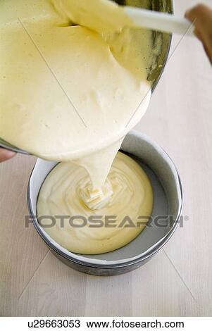 Pouring dough into a cake pan View Large Photo Image Stock Image - Pouring dough into a cake pan. Fotosearch